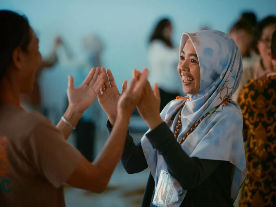 Peserta Konferensi Anthroposophy Indonesia di Bandung 2025 tersenyum bahagia saat mengikuti sesi bersama tutor, menggambarkan suasana positif dan penuh semangat belajar.