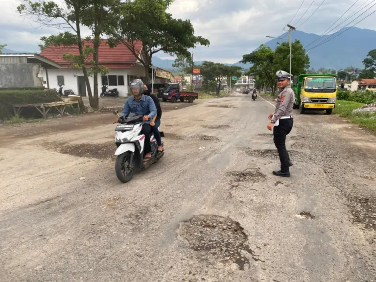 Polres Garut saat meninjau jalan rusak di wilayah hukumnya.